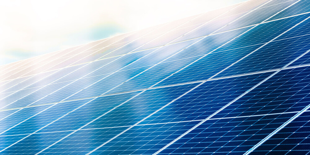 Solar,Panels,Close,Up,With,Blue,Cloud,Reflection.